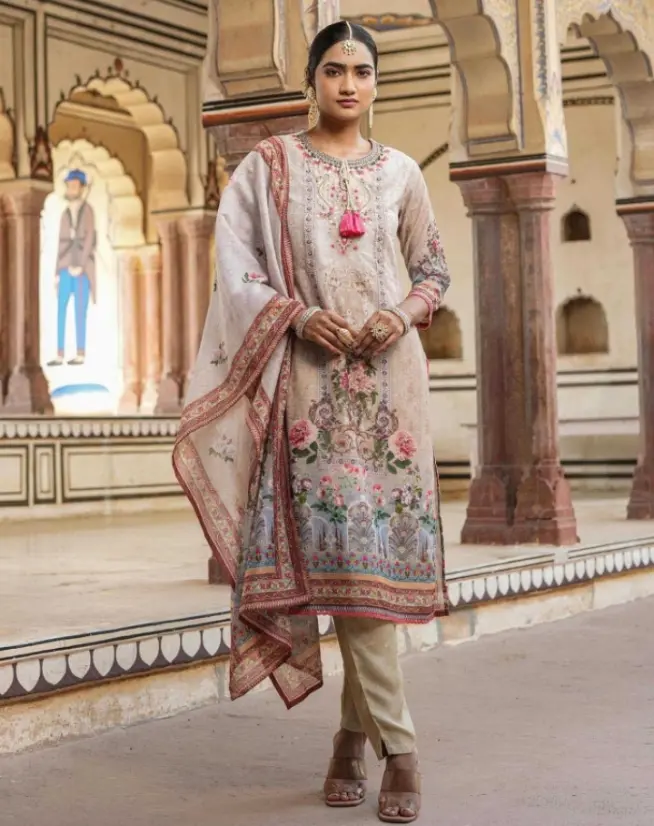 a girl stand in royal place and wear pakistani white colour suits