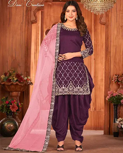 a gir;l stand wear salwar & kameez and background a studio