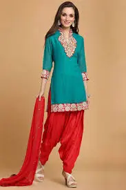 a gilrs stand of front and wear green kurtis and red pent and hang her hand red duptta